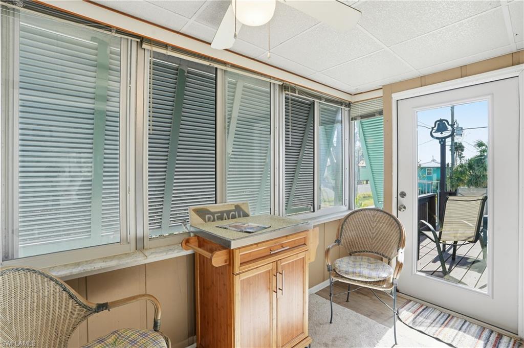 5474 Oak Ridge Avenue Fort Myers Beach, FL 33931 - Photo 37 of 50 a living room with furniture and a window