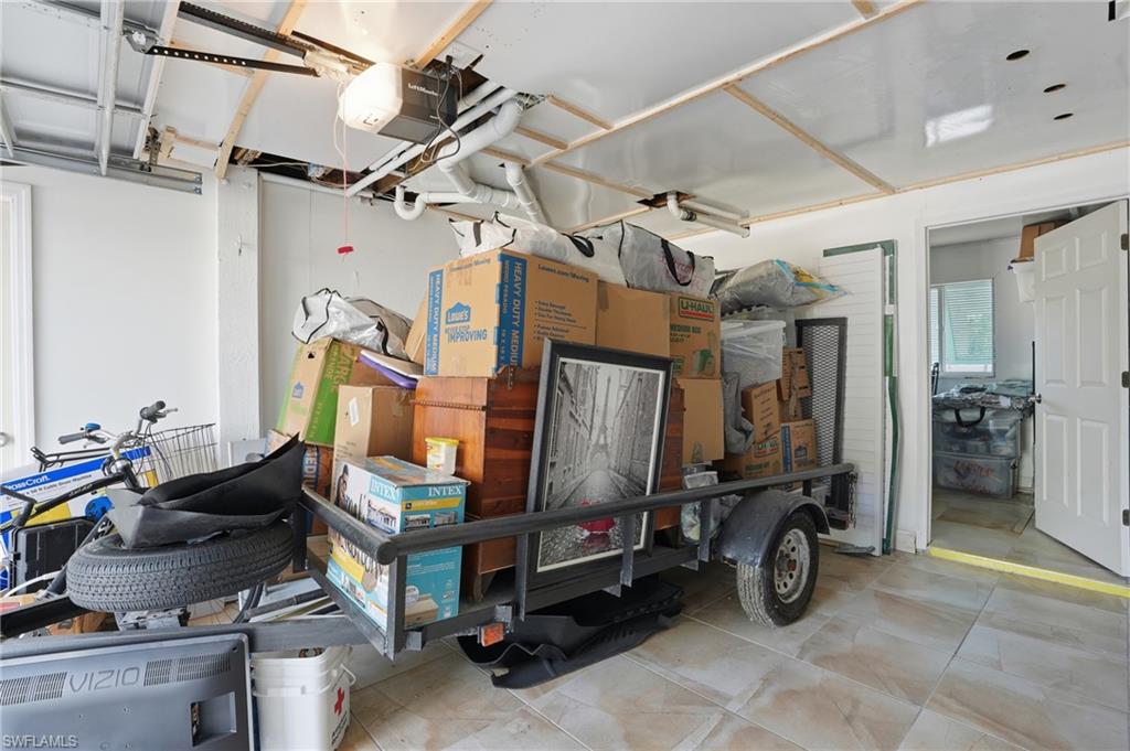 5474 Oak Ridge Avenue Fort Myers Beach, FL 33931 - Photo 43 of 50 a room with lots of furniture and gym equipment