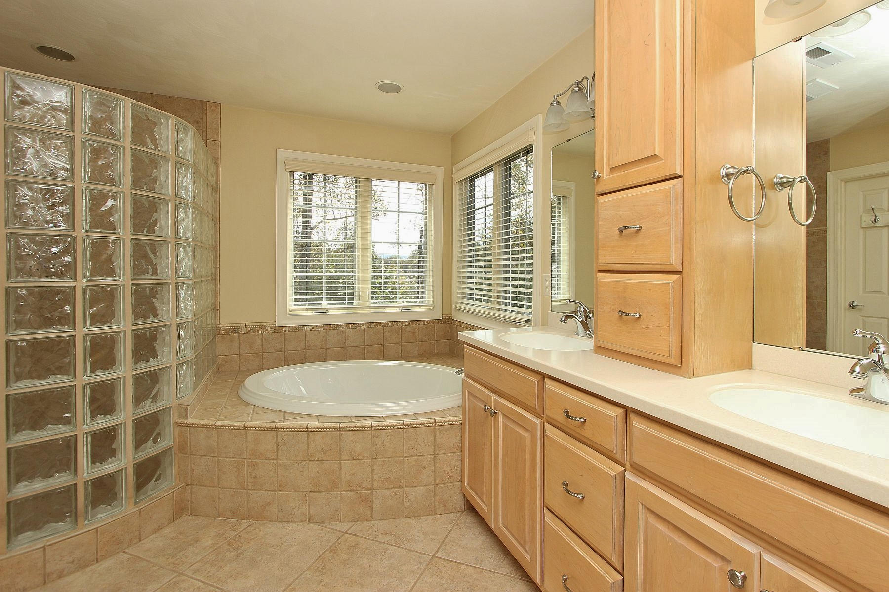 136 Claybrook Court Blue Ridge, VA 24064 - Photo 43 of 86 a spacious bathroom with a granite countertop sink a large mirror and a bathtub