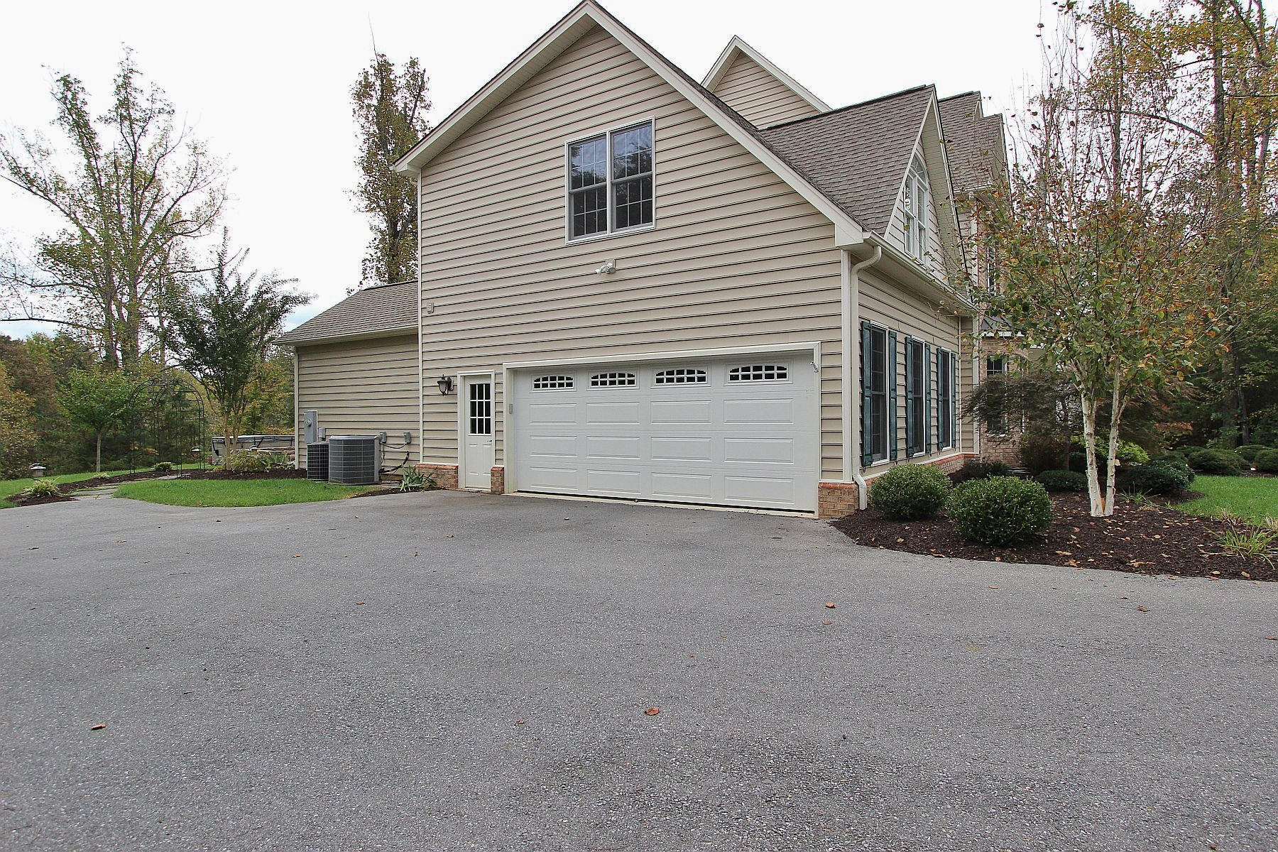 136 Claybrook Court Blue Ridge, VA 24064 - Photo 84 of 86 a view of a house with a backyard and bushes