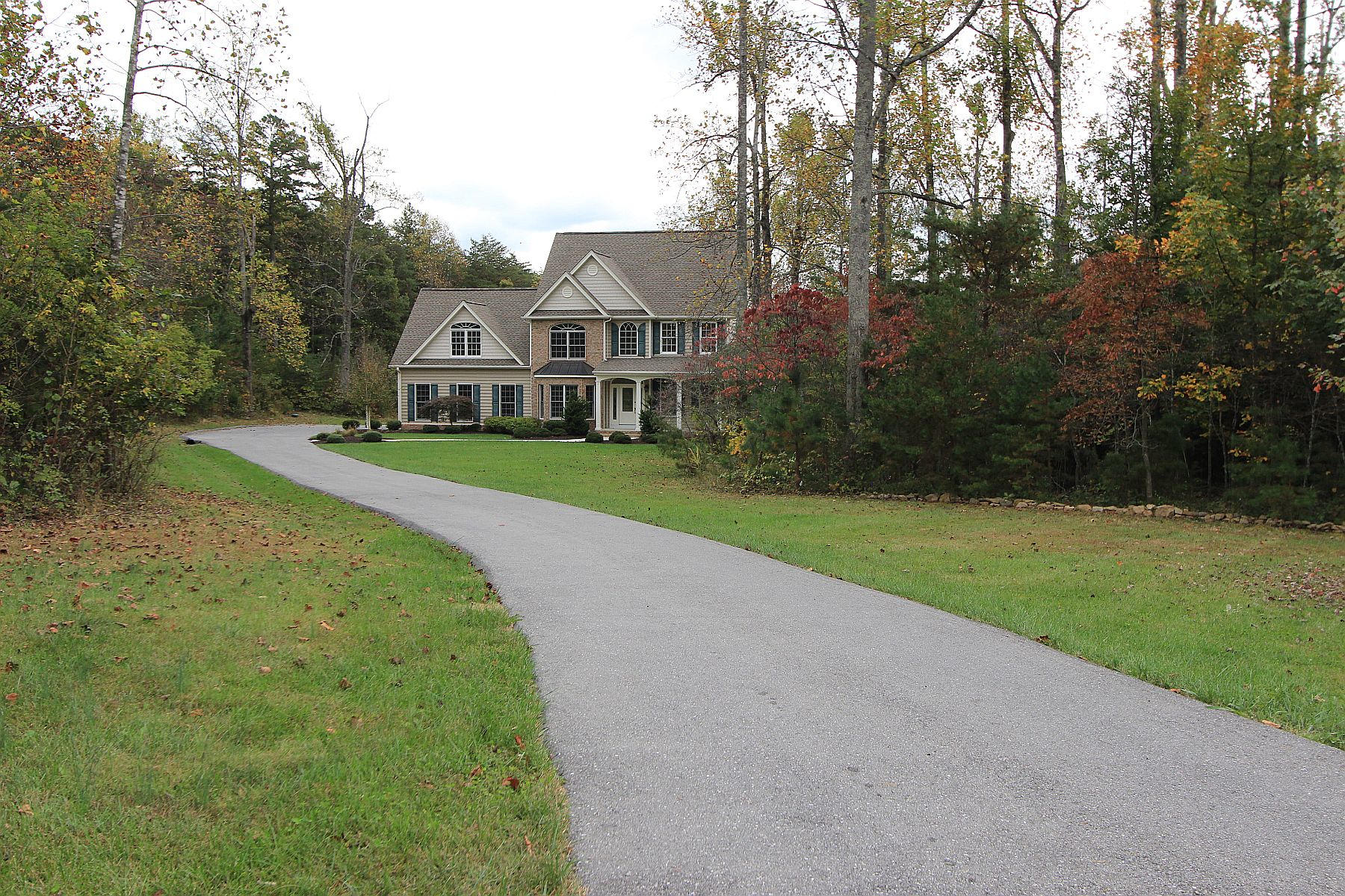 136 Claybrook Court Blue Ridge, VA 24064 - Photo 86 of 86 a front view of a house with a yard and trees