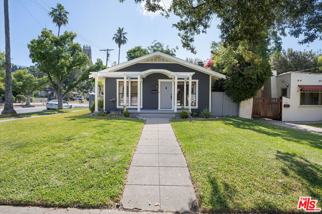a front view of a house with yard and green space