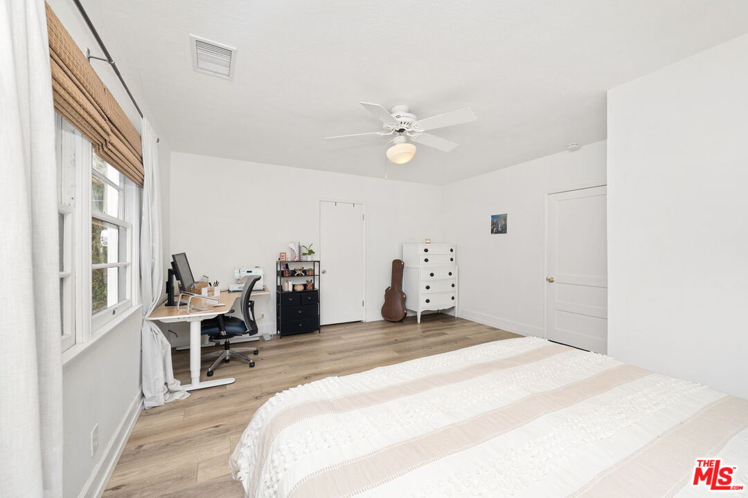 1732 Fiske Avenue Pasadena, CA 91104 - Photo 13 of 23 a spacious bedroom with a bed and a chandelier
