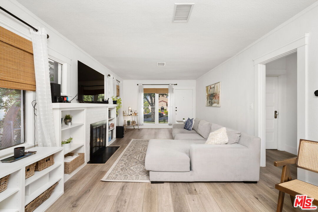 1732 Fiske Avenue Pasadena, CA 91104 - Photo 2 of 23 a living room with fireplace furniture and a flat screen tv
