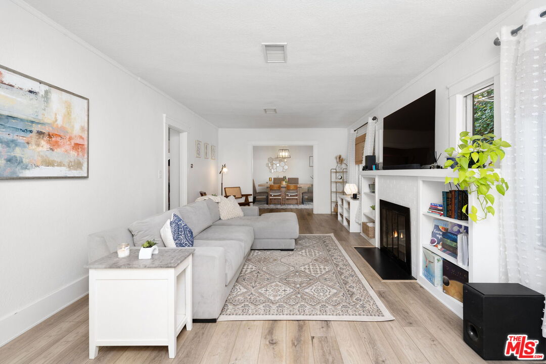 1732 Fiske Avenue Pasadena, CA 91104 - Photo 4 of 23 a living room with furniture a flat screen tv and a fireplace