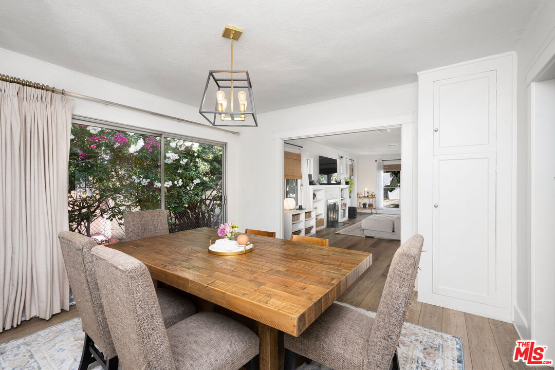 1732 Fiske Avenue Pasadena, CA 91104 - Photo 6 of 23 a dining room with wooden floor a chandelier a wooden table and chairs