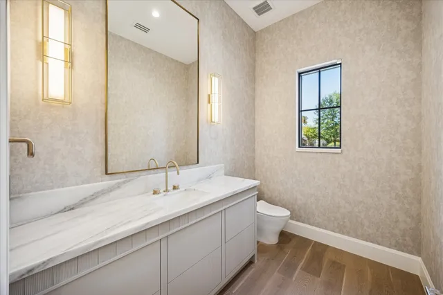 a view of empty room with wooden floor and fireplace