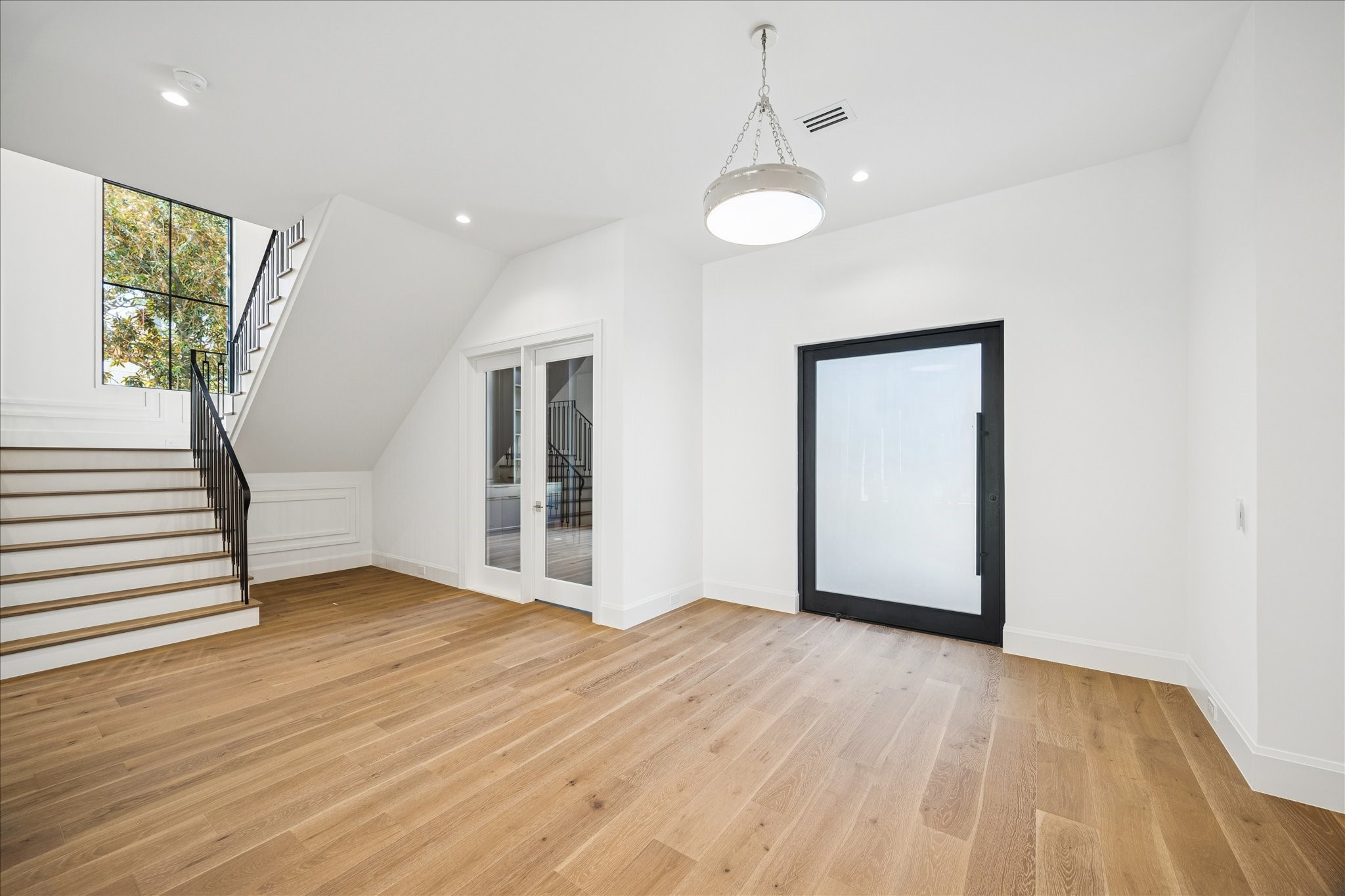 267 Maple Valley Road Houston, TX 77056 - Photo 2 of 40 a view of an empty room with wooden floor and a window