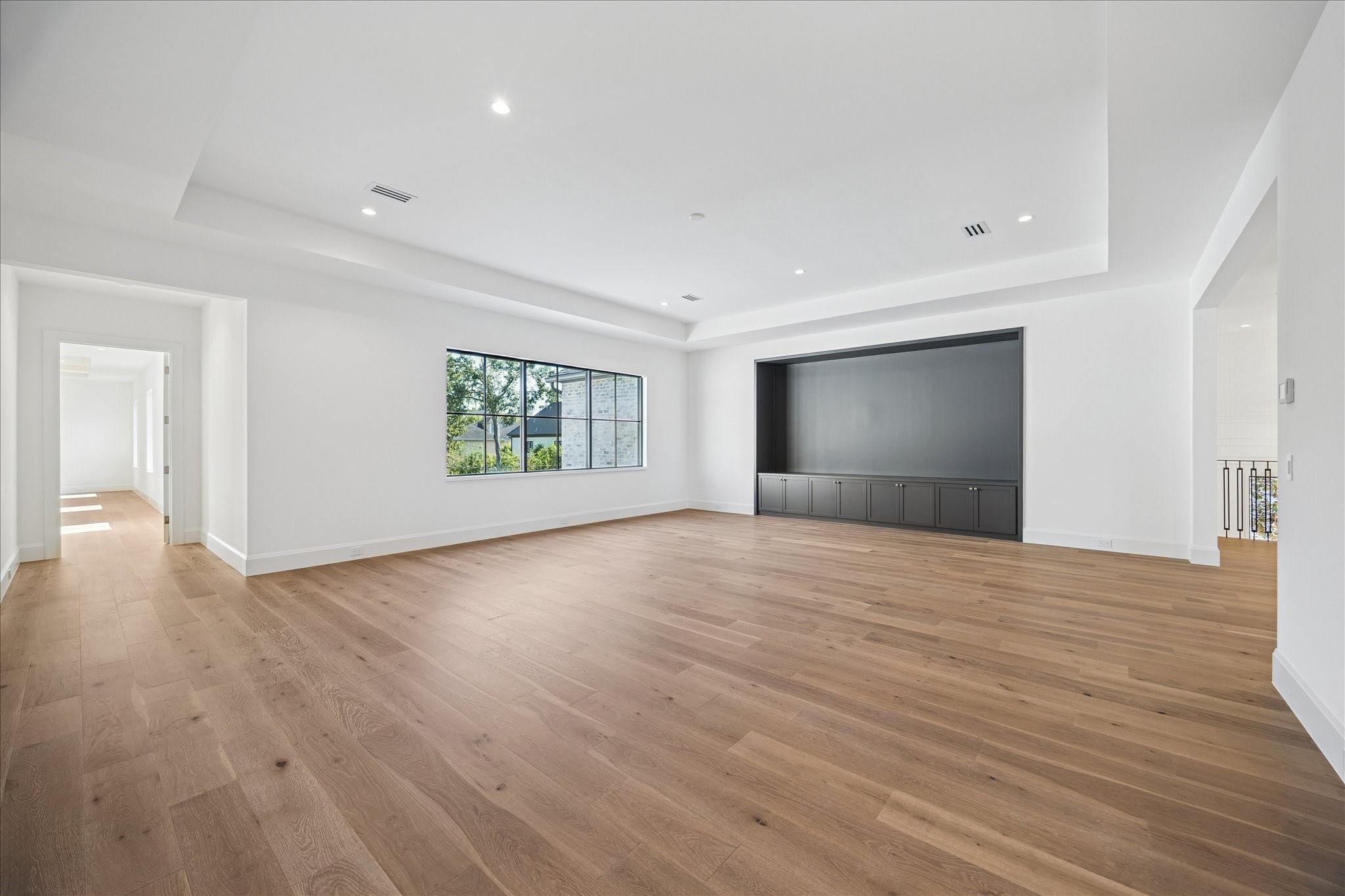 267 Maple Valley Road Houston, TX 77056 - Photo 22 of 40 a view of empty room with wooden floor and fan