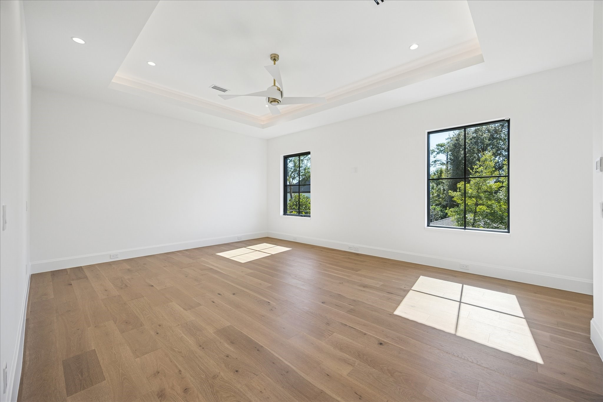 267 Maple Valley Road Houston, TX 77056 - Photo 24 of 40 an empty room with wooden floor and windows