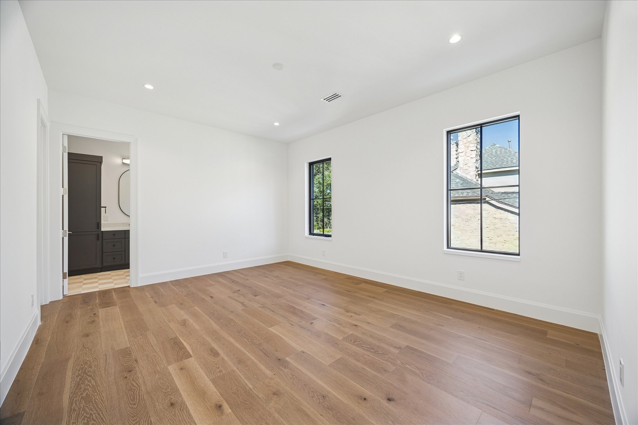 267 Maple Valley Road Houston, TX 77056 - Photo 29 of 40 an empty room with wooden floor and windows