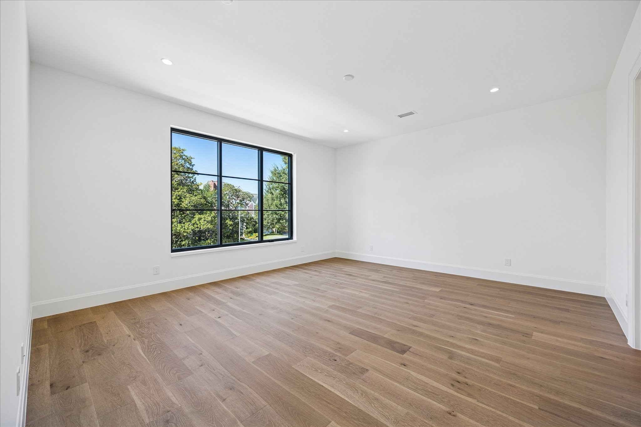 267 Maple Valley Road Houston, TX 77056 - Photo 31 of 40 a view of an empty room with wooden floor and a window