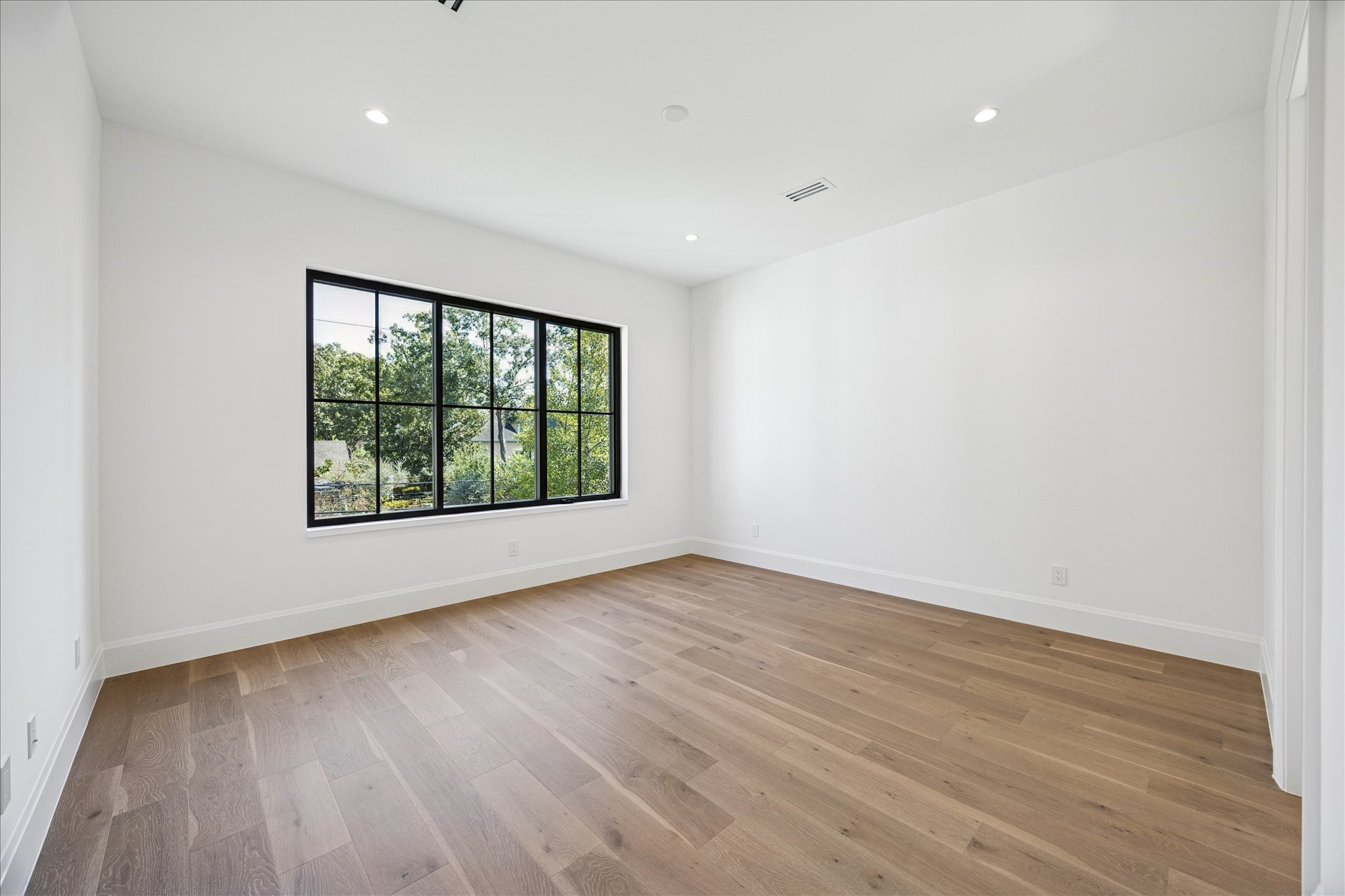 267 Maple Valley Road Houston, TX 77056 - Photo 33 of 40 a view of an empty room with wooden floor and a window