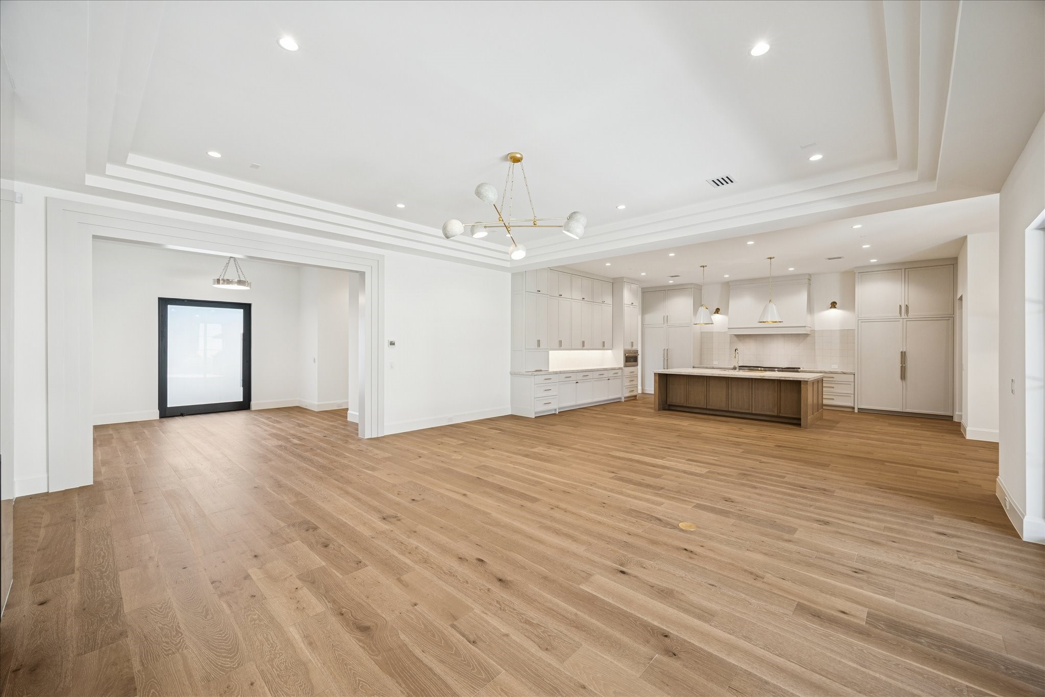 267 Maple Valley Road Houston, TX 77056 - Photo 5 of 40 a view of kitchen and empty room with wooden floor