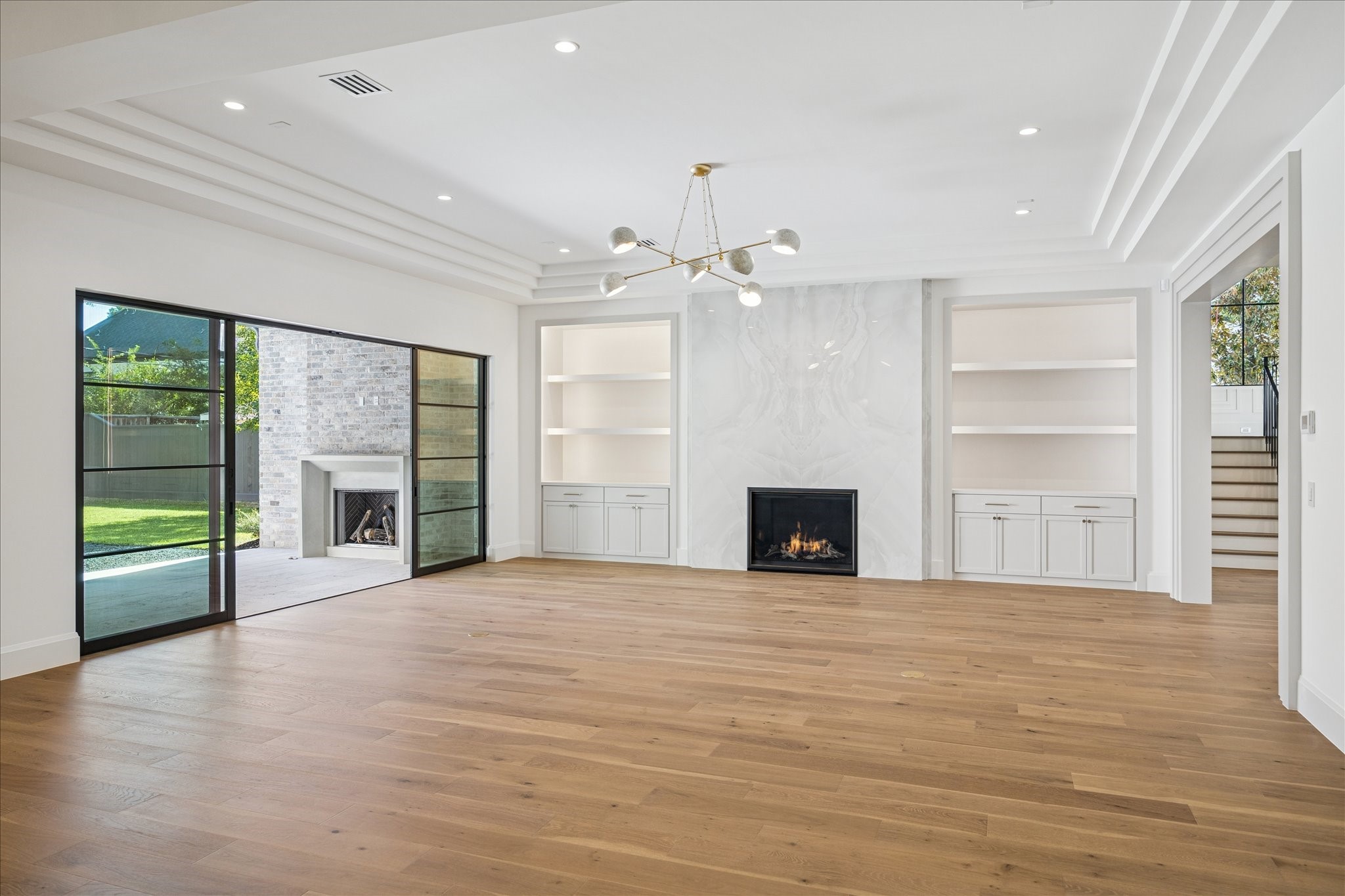 267 Maple Valley Road Houston, TX 77056 - Photo 6 of 40 an empty room with windows and a fireplace