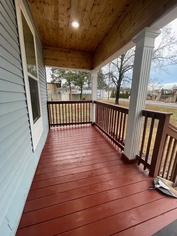 a view of a balcony with wooden floor