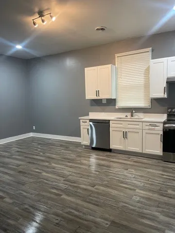 a view of kitchen with wooden floor