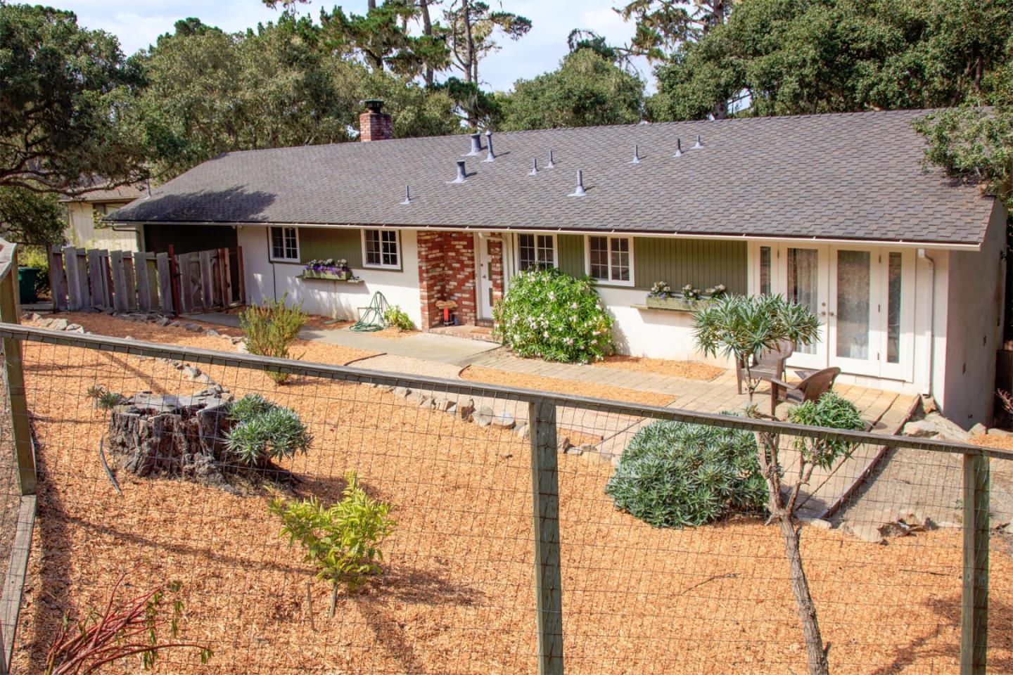 3112 Sloat Road Pebble Beach, CA 93953 - Photo 1 of 26 a view of house with a yard and potted plants