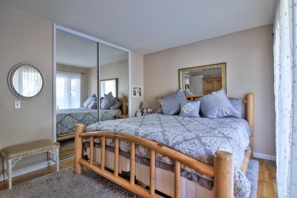 3112 Sloat Road Pebble Beach, CA 93953 - Photo 14 of 26 a bedroom with a bed a mirror and dresser