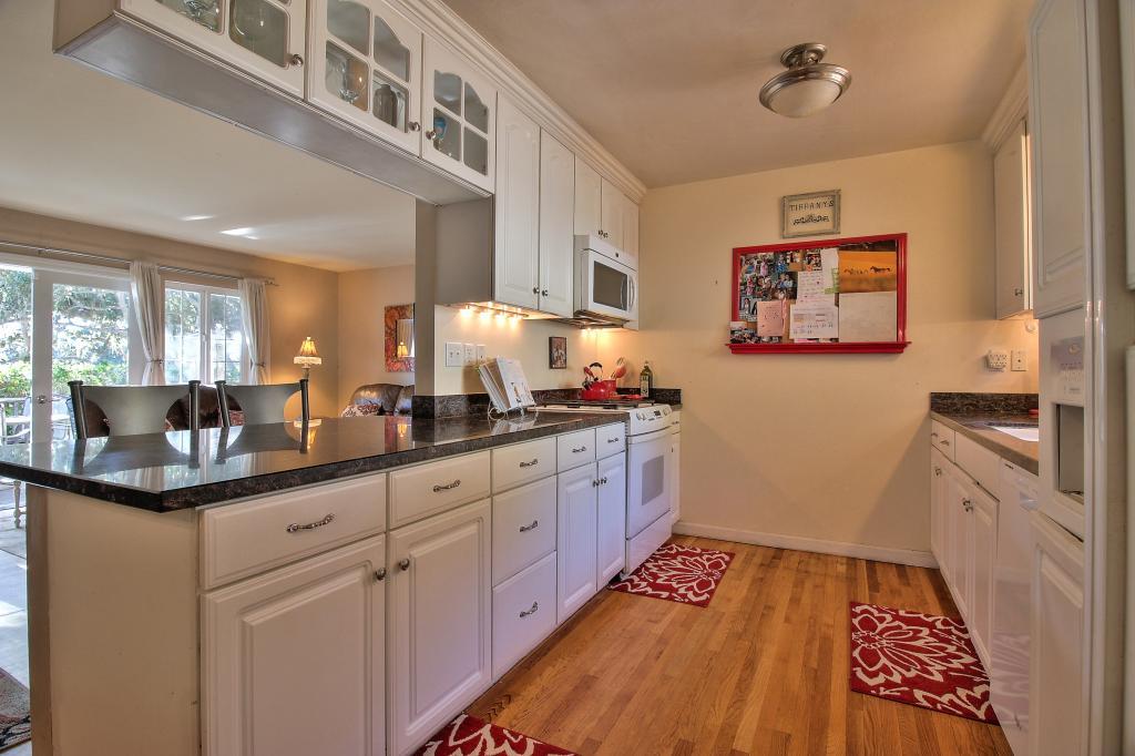 3112 Sloat Road Pebble Beach, CA 93953 - Photo 8 of 26 a kitchen with granite countertop a sink and cabinets