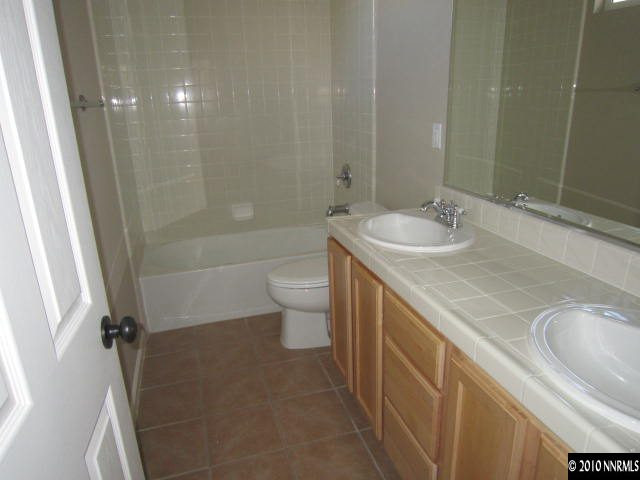 2540 Country Falls Lane Reno, NV 89521 - Photo 8 of 13 a bathroom with a sink a toilet and shower