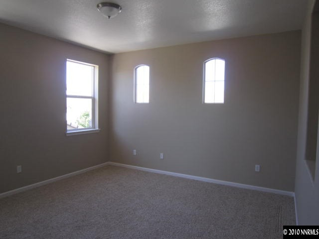 2540 Country Falls Lane Reno, NV 89521 - Photo 10 of 13 an empty room with windows and closet