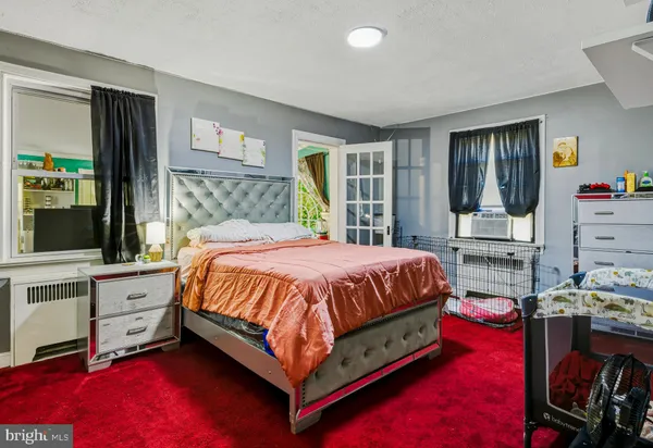 a bed sitting in a bedroom next to a window