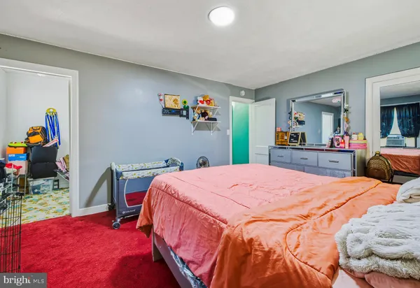 a bedroom with a bed and a desk