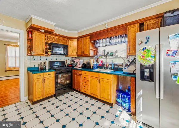 a kitchen with stainless steel appliances a stove a sink and a refrigerator