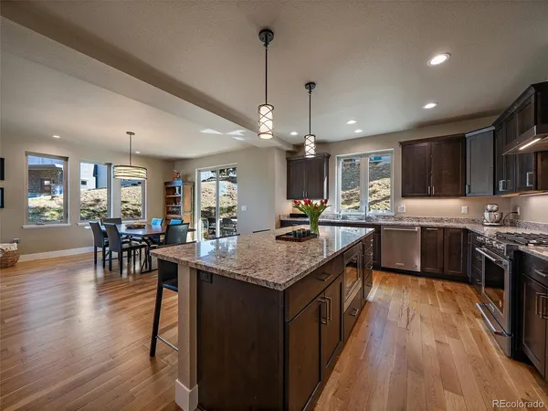 a kitchen with counter top space a sink appliances and wooden floor