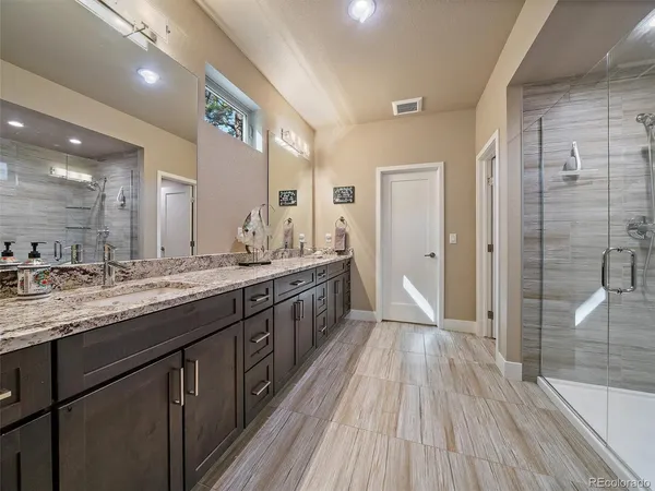 a large bathroom with a double vanity sink and a mirror