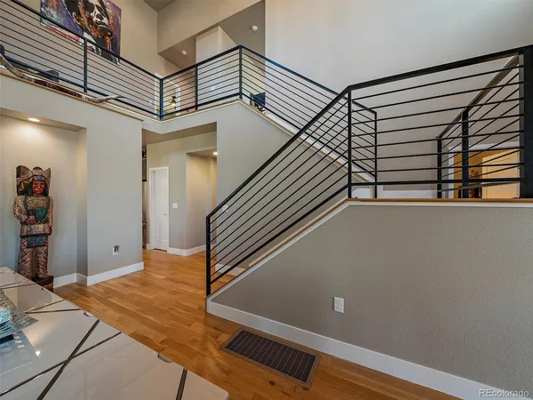 a view of staircase with furniture and a chandelier