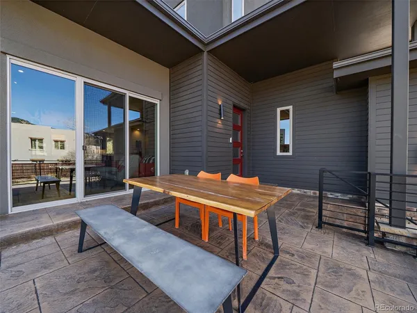 a backyard of a house with barbeque oven table and chairs