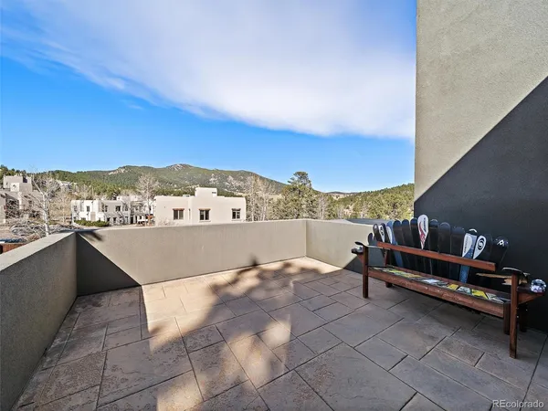 a view of a patio with table and chairs and potted plants