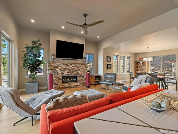 a living room with furniture a flat screen tv and a fireplace