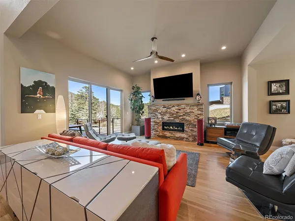 a living room with fireplace furniture and a flat screen tv