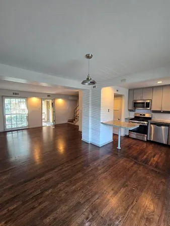a view of kitchen with microwave and wooden floor