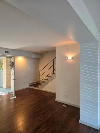 a view of empty room with wooden floor