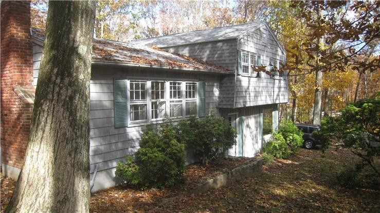 front view of a house with a tree
