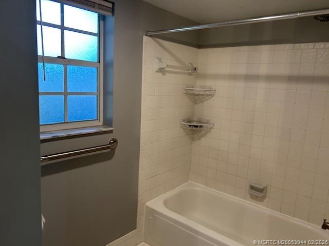 803 Southeast Central Parkway, Unit 5 Stuart, FL 34994 - Photo 11 of 19 a bathroom with a bathtub and a shower