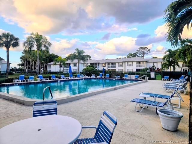 803 Southeast Central Parkway, Unit 5 Stuart, FL 34994 - Photo 19 of 19 a swimming pool with outdoor seating and lake view