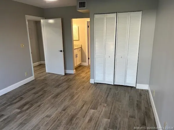 a view of hallway with wooden floor