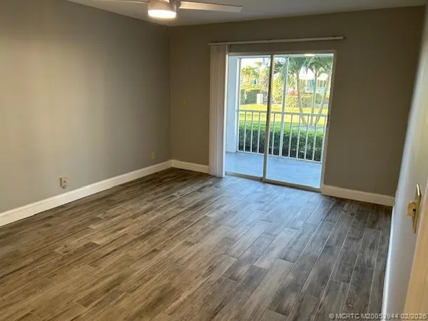 a view of wooden floor and windows in a room