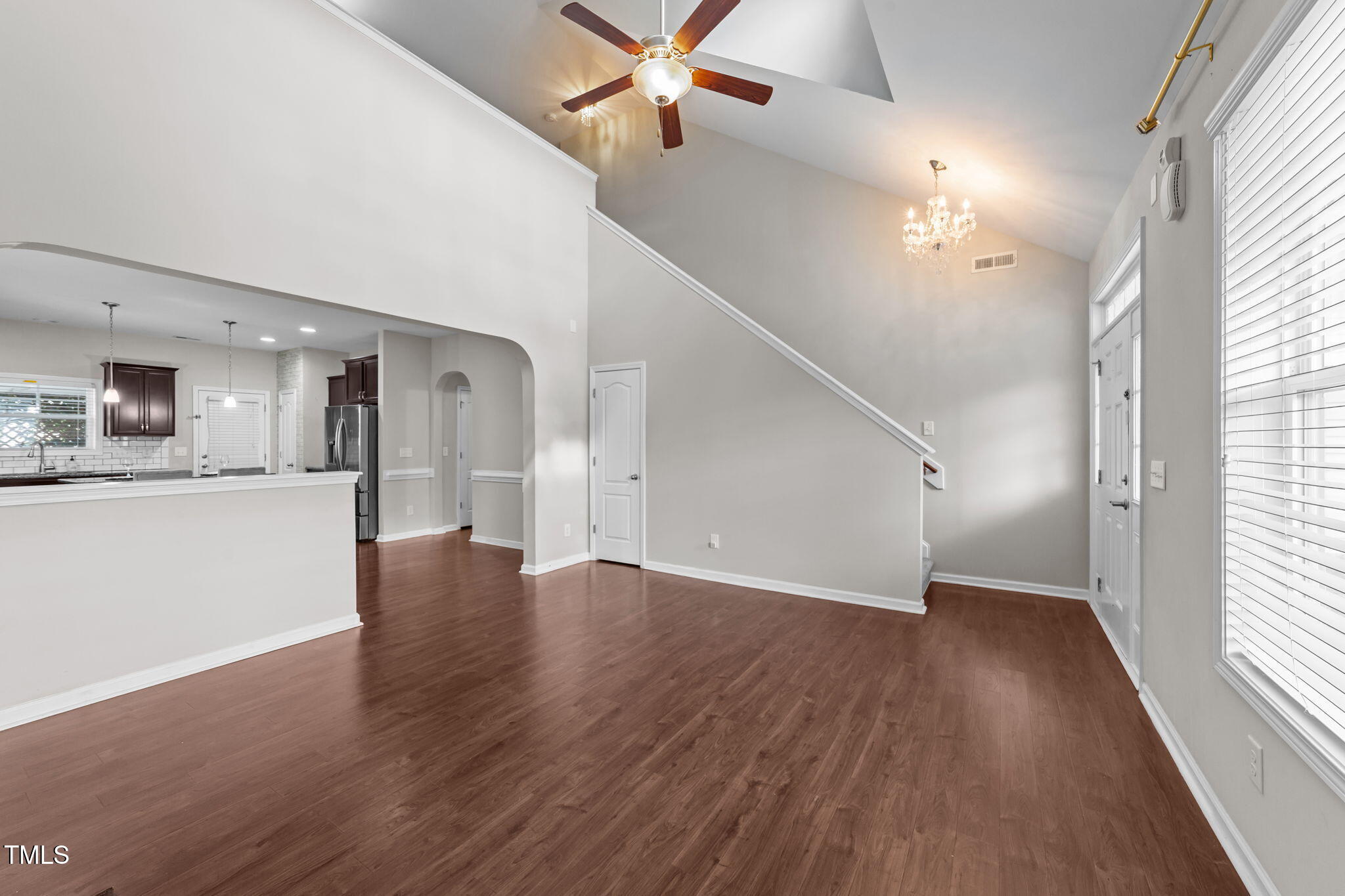 83 Mariners Point Way Garner, NC 27529 - Photo 11 of 49 a view of a hallway with wooden floor and a kitchen
