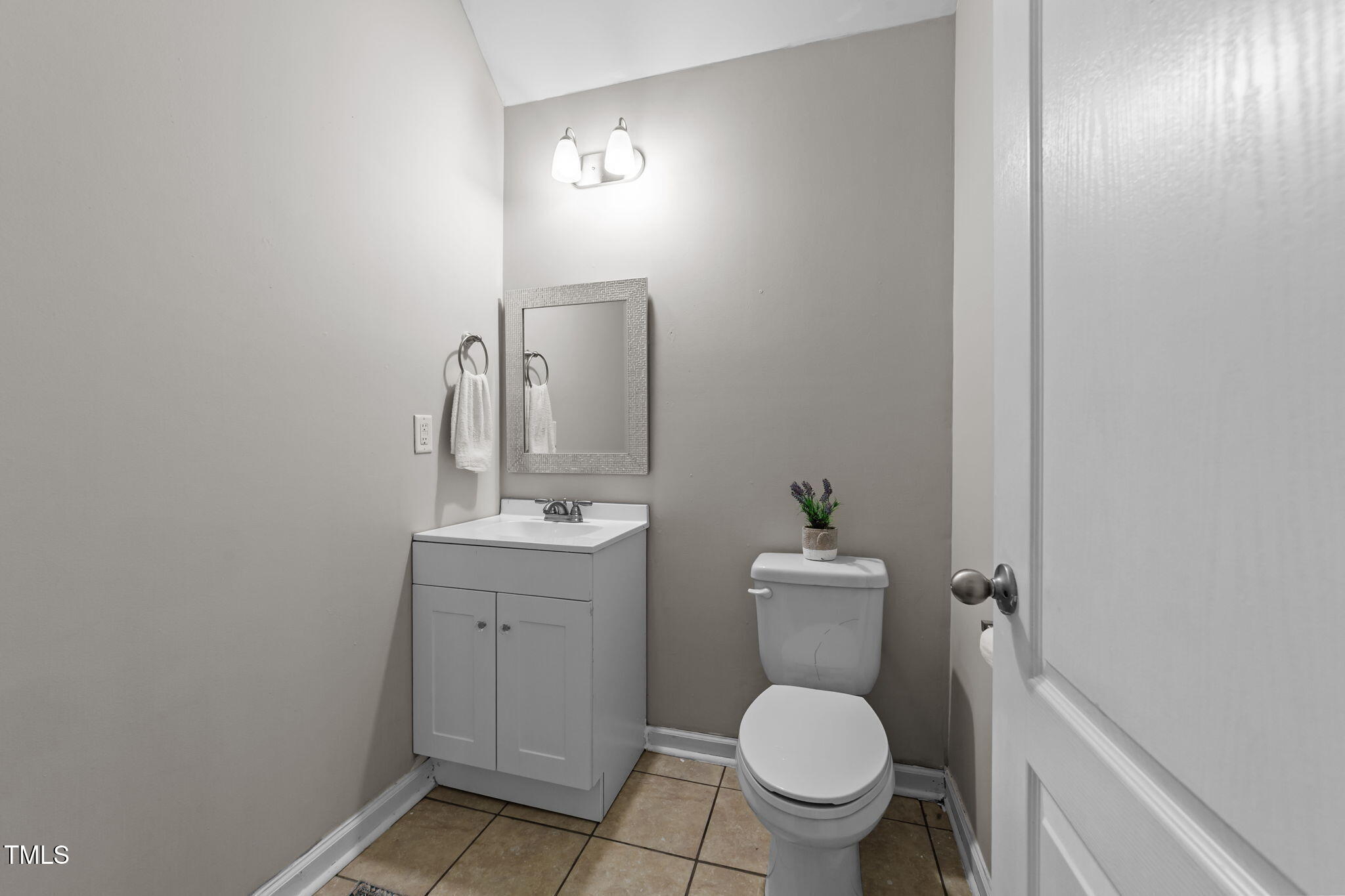 83 Mariners Point Way Garner, NC 27529 - Photo 14 of 49 a bathroom with a toilet a sink and mirror