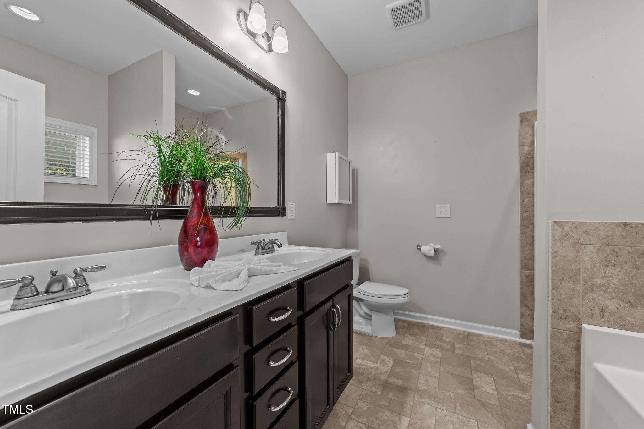 83 Mariners Point Way Garner, NC 27529 - Photo 17 of 49 a bathroom with a granite countertop sink a toilet and a mirror
