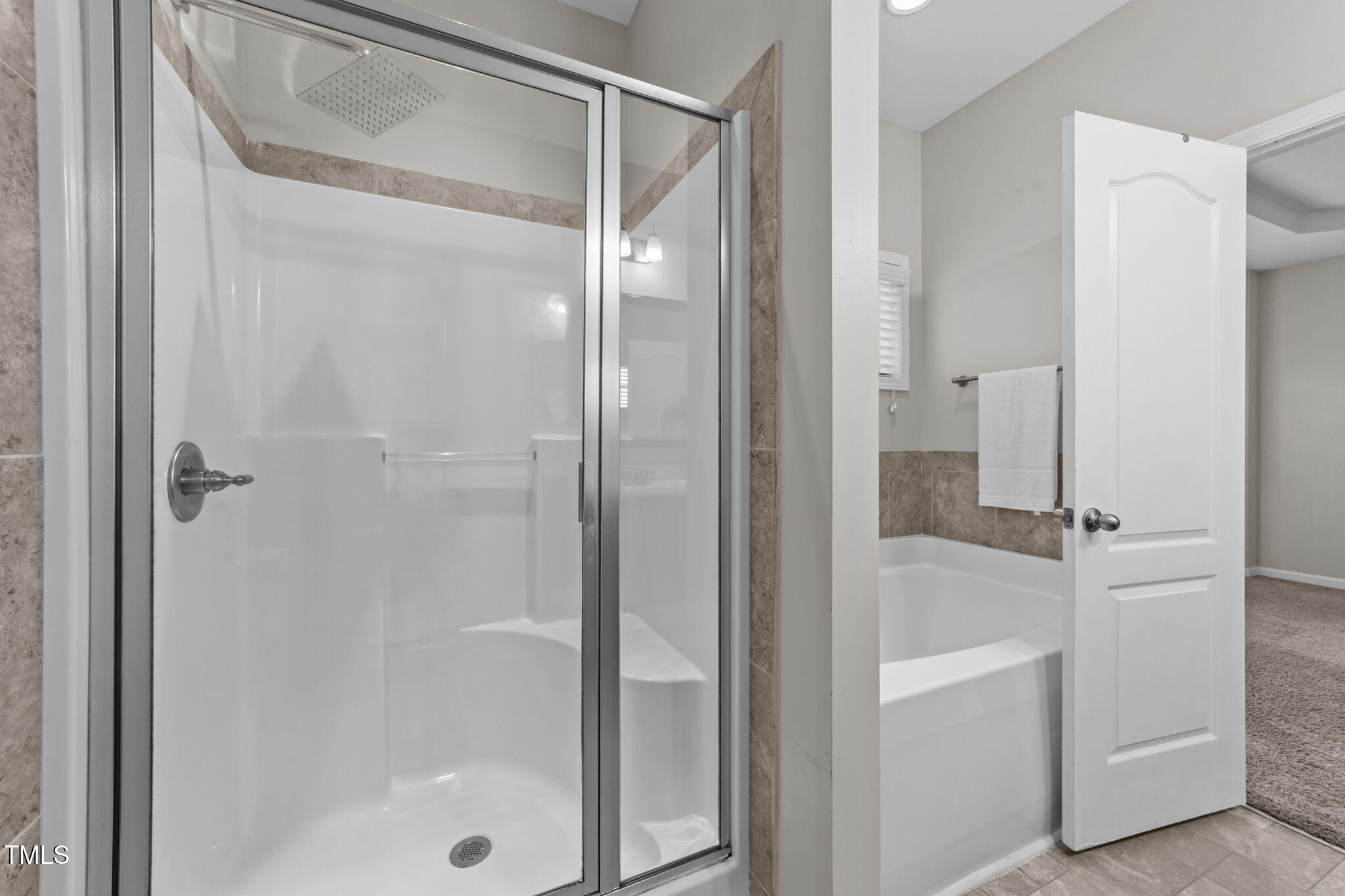 83 Mariners Point Way Garner, NC 27529 - Photo 18 of 49 a bathroom with a glass shower door