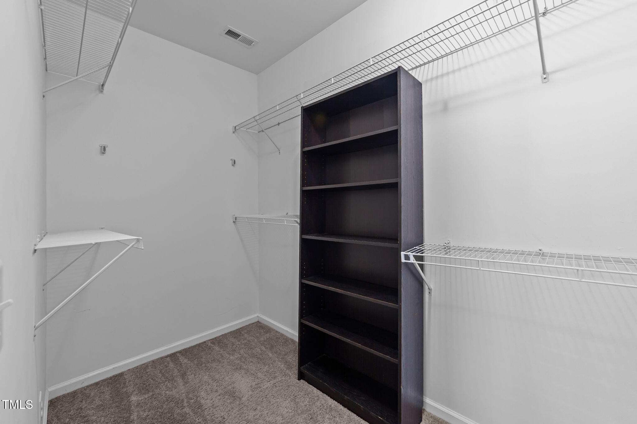 83 Mariners Point Way Garner, NC 27529 - Photo 19 of 49 a view of walk in closet with empty racks