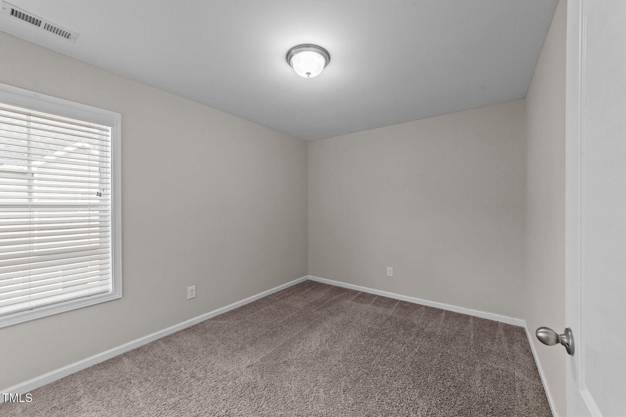 83 Mariners Point Way Garner, NC 27529 - Photo 25 of 49 an empty room with a window and fan