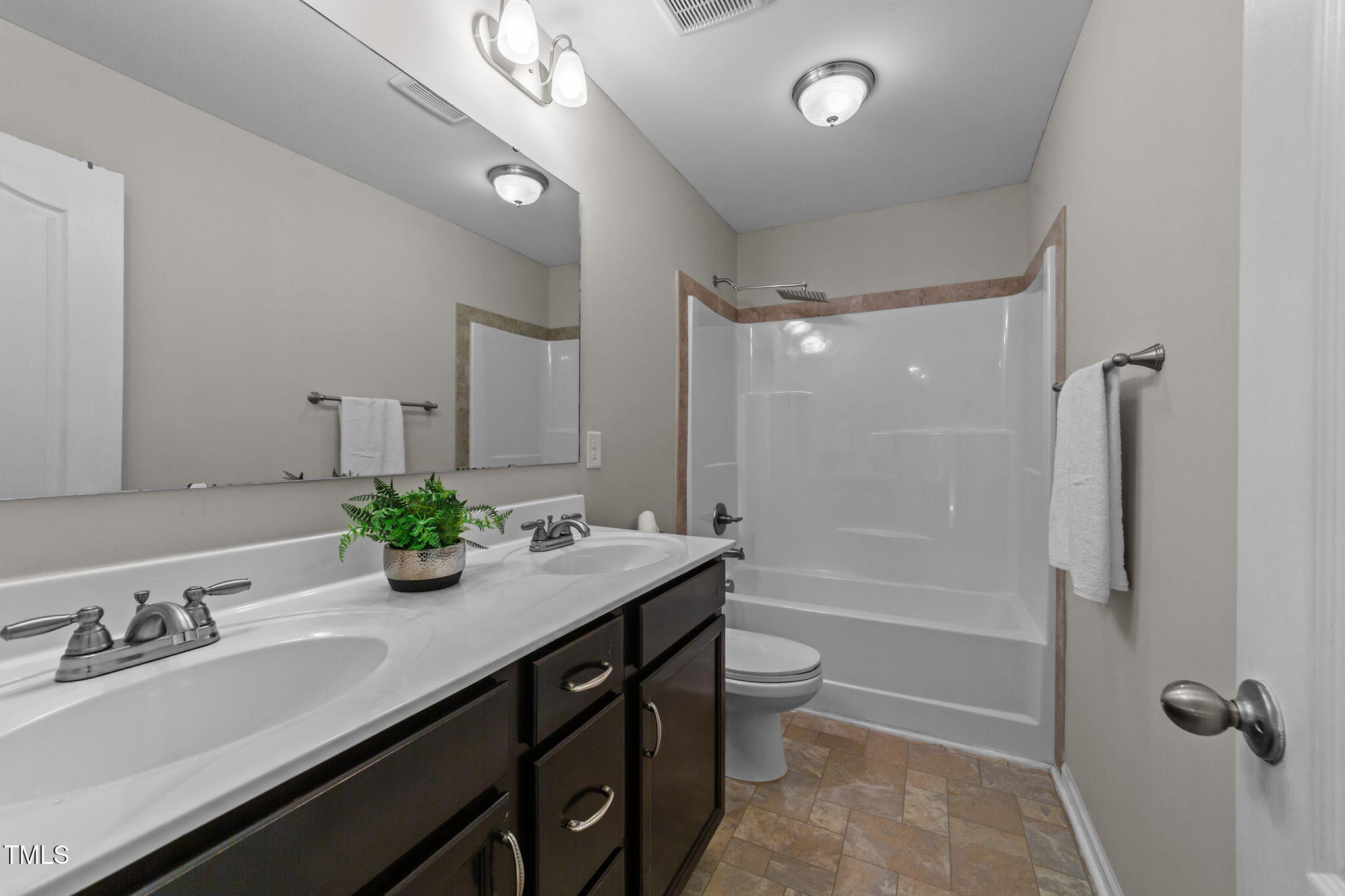 83 Mariners Point Way Garner, NC 27529 - Photo 26 of 49 a bathroom with a granite countertop sink mirror toilet and bathtub